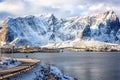 Amazing winter landscape, Lofoten Islands, Hamnoy, Norway. Scenic view of the snowy rocky mountains, water and blue sky with cloud Royalty Free Stock Photo