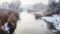 Amazing winter landscape in the public park. Scenic view of the river and reflection of frosty trees in the water. Panorama nature Royalty Free Stock Photo