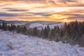 Amazing winter landscape, scenic sunset view of the snowy mountains, fir trees and colorful sky, outdoor travel background Royalty Free Stock Photo