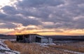 Amazing winter sunset over humble shanty and farmlands