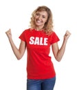 Amazing woman with curly blond hair and sales-shirt