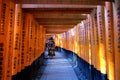 Amazing wooden orange color gate with japan quote in its side and japanese girl wearing kimono