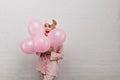 Amazing young lady wears silk pajama celebrating birthday. Studio portrait of adorable girl in sleepmask holding