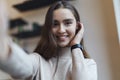 Amazing young smiling woman is looking the camera. Model posing in front of the camera during photo shooting. Female taking selfie Royalty Free Stock Photo