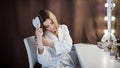 Amazing young woman brush her hair in front of mirror. Portrait of beautiful girl Royalty Free Stock Photo