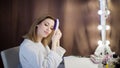 Amazing young woman brush her hair in front of mirror. Portrait of beautiful girl Royalty Free Stock Photo