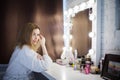 Amazing young woman brush her hair in front of mirror. Portrait of beautiful girl Royalty Free Stock Photo