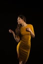 Amazing young woman with long hair posing in yellow dress in the Royalty Free Stock Photo