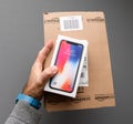 Amazon box and Apple iphone X10 against gray background