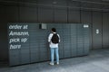 Amazon client at the pickup locker to collect a package in London England United Kingdom