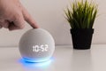 Voice controlled speaker with activated voice recognition, on light background and finger