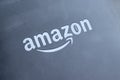 Amazon logo on the gray back of a Kindle electronic book. Selective focus. Closeup view Royalty Free Stock Photo