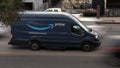 Amazon Prime Delivery Van Parked Among Cars Speeding By Royalty Free Stock Photo