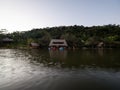 Amazon tropical rainforest exotic lush jungle eco lodge hotel wooden cabin stilt hut at river lake in South America