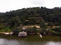 Amazon tropical rainforest exotic lush jungle eco lodge hotel wooden cabin stilt hut at river lake in South America