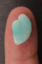 Amazonite jewel stone texture on the finger Royalty Free Stock Photo