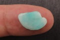 Amazonite jewel stone texture on the finger Royalty Free Stock Photo