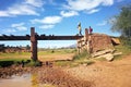 Ambalavao, Madagascar - April 27, 2019: Unknown Malagasy boy carrying bag on his head over simple bridge, another one smiling Royalty Free Stock Photo