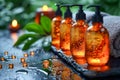 Amber bottles filled with fragrant oils are elegantly arranged on a dark stone surface, complemented by flickering Royalty Free Stock Photo