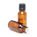 Amber color small glass bottle with pin hole dropper and black cap Royalty Free Stock Photo