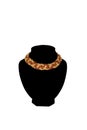 Amber colored beaded necklace on black velvet bust isolated on white background. Female accessories, decorative ornaments