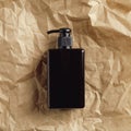 Amber glass soap dispenser bottle on crumpled paper, top view. Natural organic cosmetics packaging design