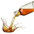 Amber liquid pouring from clear glass bottle Royalty Free Stock Photo