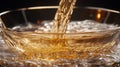 Amber liquid pours into a glass bowl Royalty Free Stock Photo