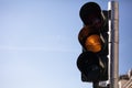 Amber, yellow traffic lights for cars, blue sky background