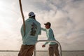 A fishing guide instructs a fly fisherman on bonefishing technique in Belize, Central America