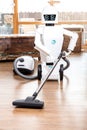 Ambient assisted living roboter is vacuuming