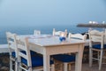 Ambient atmospheric evening on Greek coast, white tables in rest