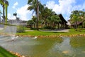 Paisagismo tropical com jardins, lago e construÃÂ§ÃÂµes com material natural Royalty Free Stock Photo