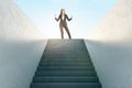 Ambition Concept With Joyful Businesswoman In Black Suit On Top Of Stairway On Sky Background