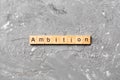 Ambition word written on wood block. ambition text on cement table for your desing, concept Royalty Free Stock Photo