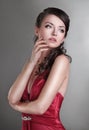 Ambitious beautiful woman in a red dress.isolated on dark
