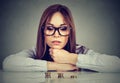 Ambitious business woman looking at growing stack of coins Royalty Free Stock Photo