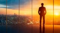 Ambitious Businessman Analyzing Future Projects with Stunning Cityscape and Sunset View from Office Royalty Free Stock Photo