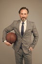 Ambitious coach. Business coach hold basketball ball. Basketball coach grey background. Confident coach or teacher in