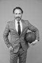 Ambitious coach. Business coach hold basketball ball. Basketball coach grey background. Confident coach or teacher in