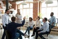 Male worker raise hand asking question at office teambuilding Royalty Free Stock Photo