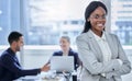 Ambitious and ready to prove it. Portrait of a confident young businesswoman standing in an office with her colleagues Royalty Free Stock Photo