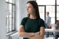 Ambitious strict businesswoman looking out the window thinking and planning