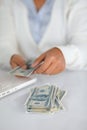 Ambitious young woman counting cash money