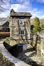Ambleside in the Lake District Cumbria UK 20 March 2018 a house built on a bridge Royalty Free Stock Photo