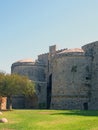 Amboise gate in the medieval walls of the old city in rhodes town surrounded by grass and trees Royalty Free Stock Photo