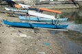 several colorful fishing boats are on the sand near the sea Royalty Free Stock Photo