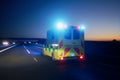 Ambulance car of emergency medical service on highway at night Royalty Free Stock Photo