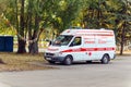 The ambulance car is parked in the park. Text in Russian: first private ambulance