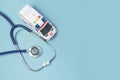 Ambulance car and stethoscope and on a blue background. concept calling doctor to home check up Royalty Free Stock Photo